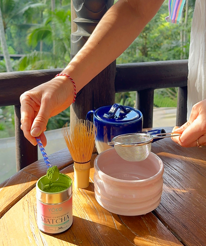 Preparing ceremonial grade matcha with bamboo whisk