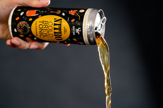 raposa nitro cold brew tonic pouring shot with hand