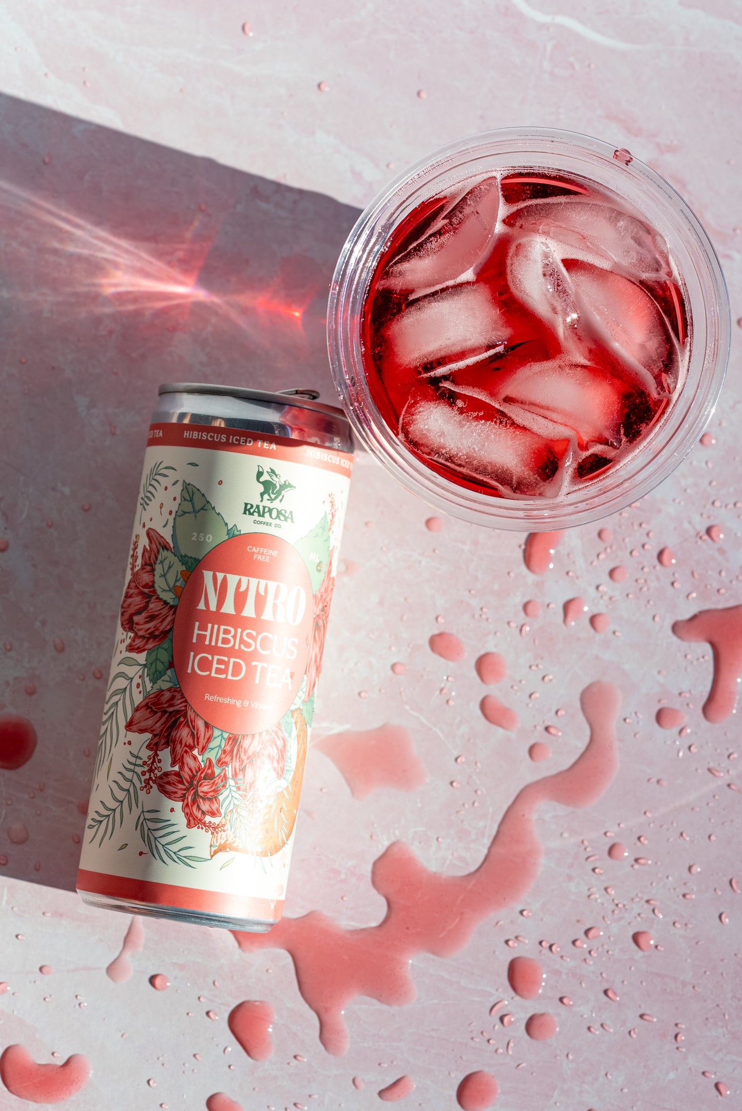 Raposa Hibiscus Iced Tea can on pink background