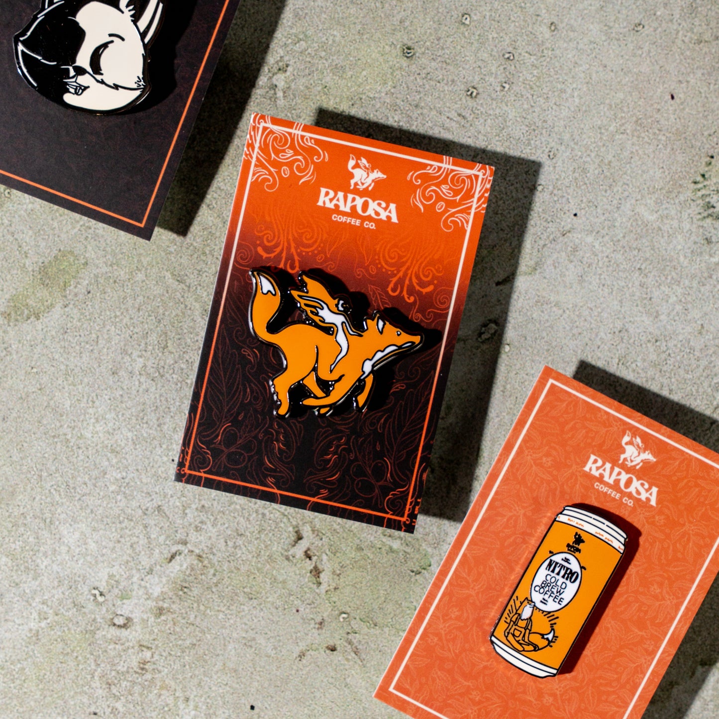 raposa metal enamel pins displayed in branded packaging
