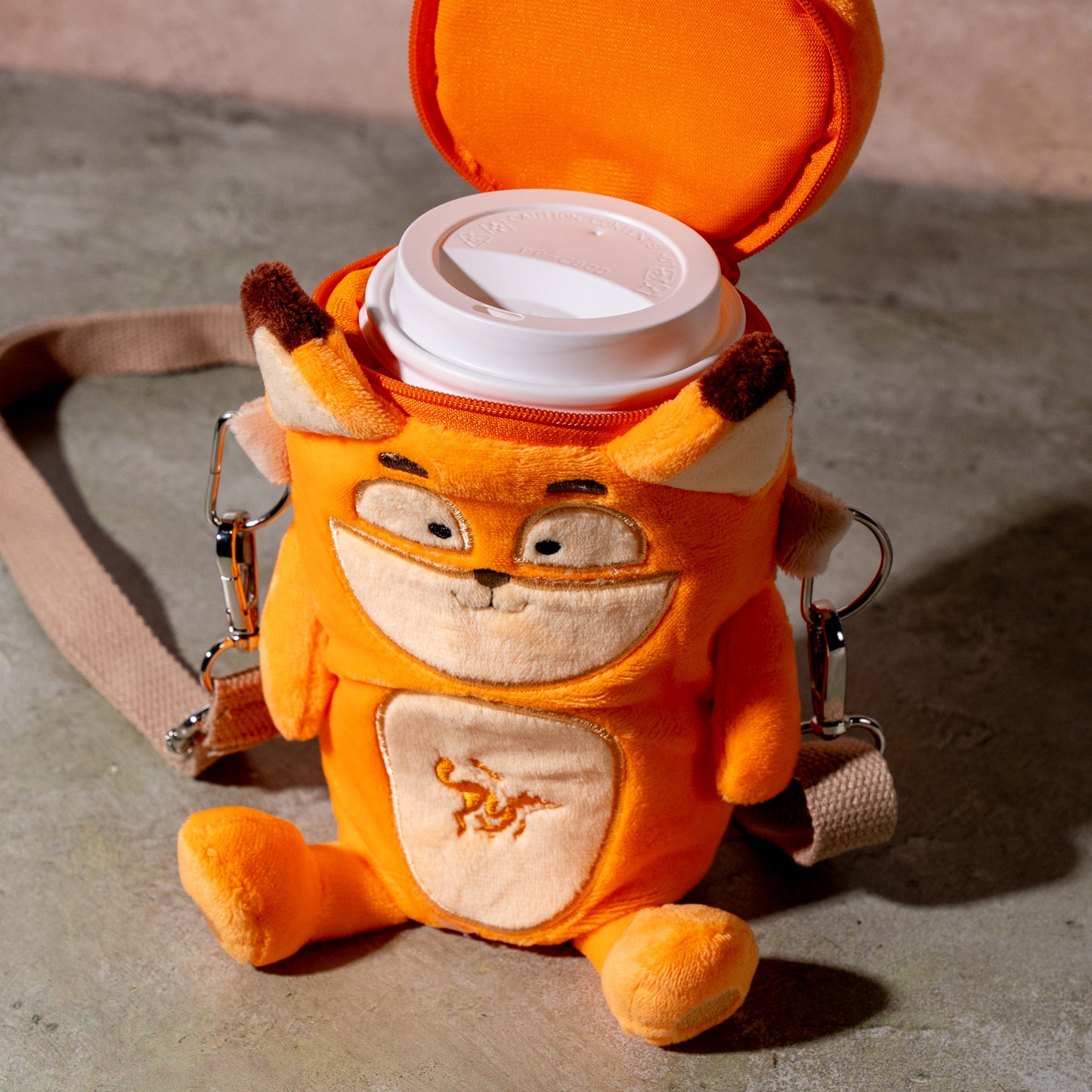 fox plush coffee cup holder with hot coffee cup inside, top view