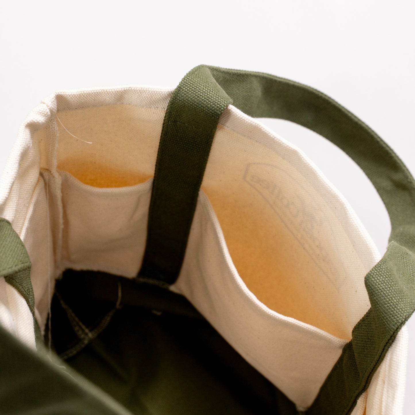 interior of raposa canvas tote bag showing inner pockets and storage capacity