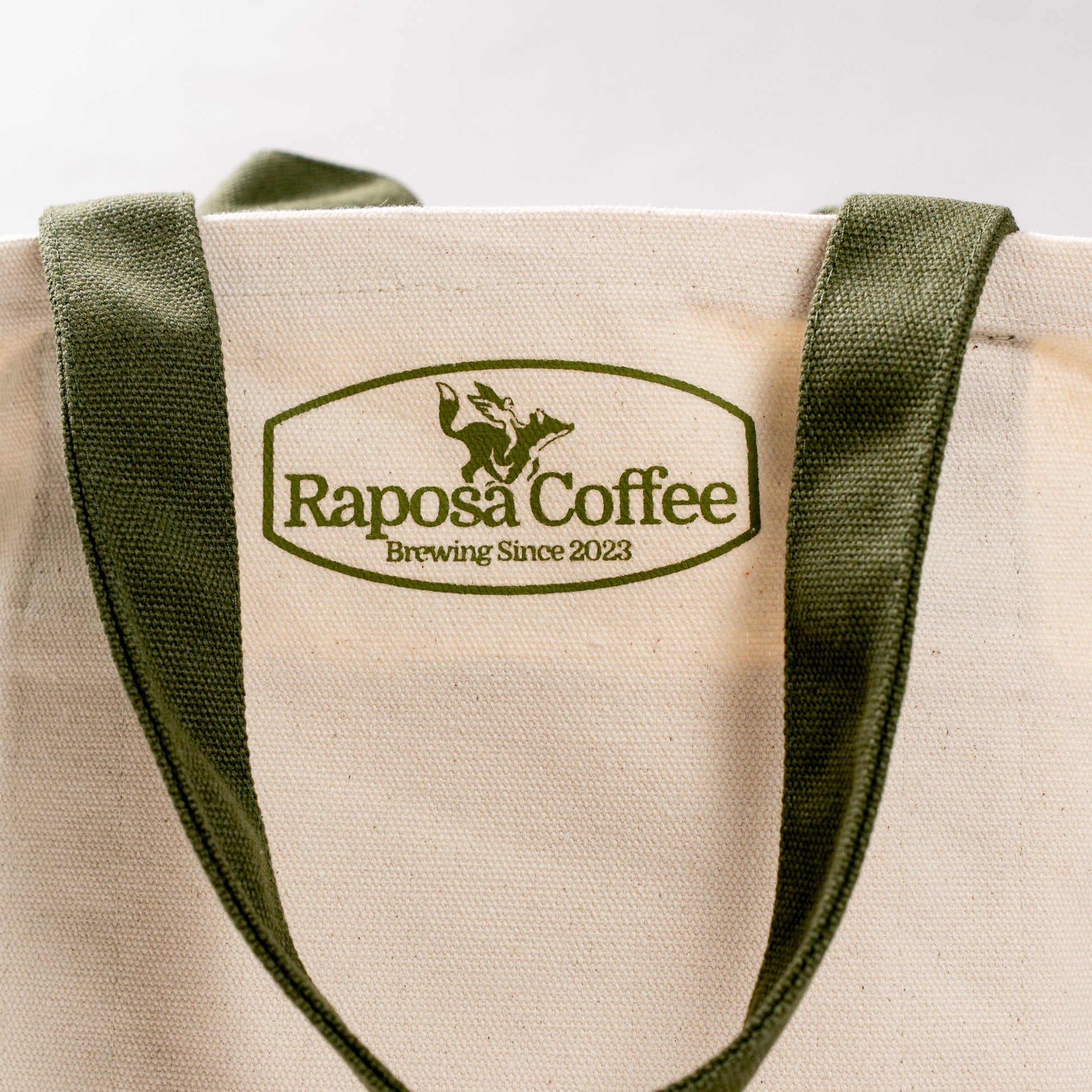 back view of raposa new york canvas tote bag with raposa coffee co logo