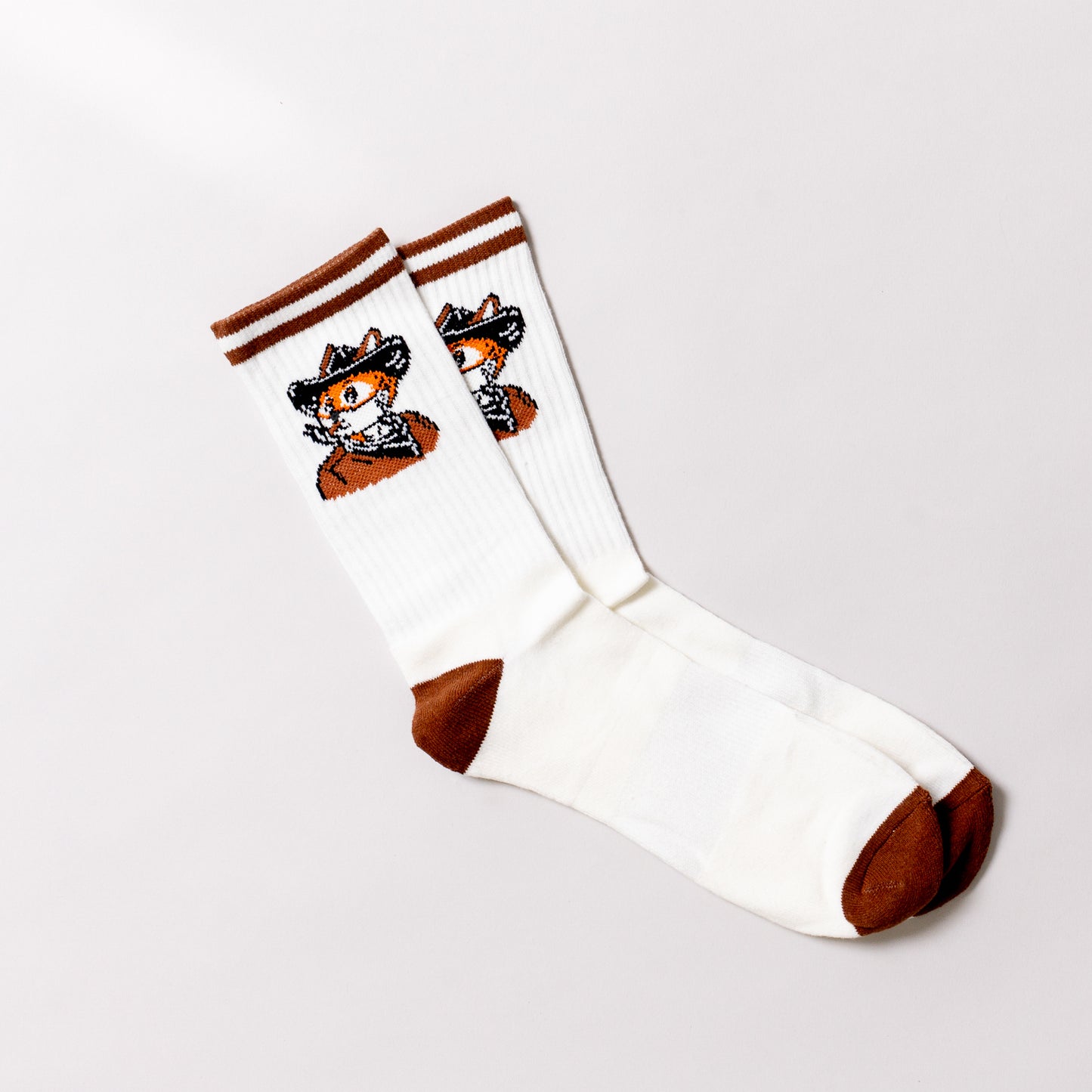 White socks with brown accents and a fox design on a light gray background