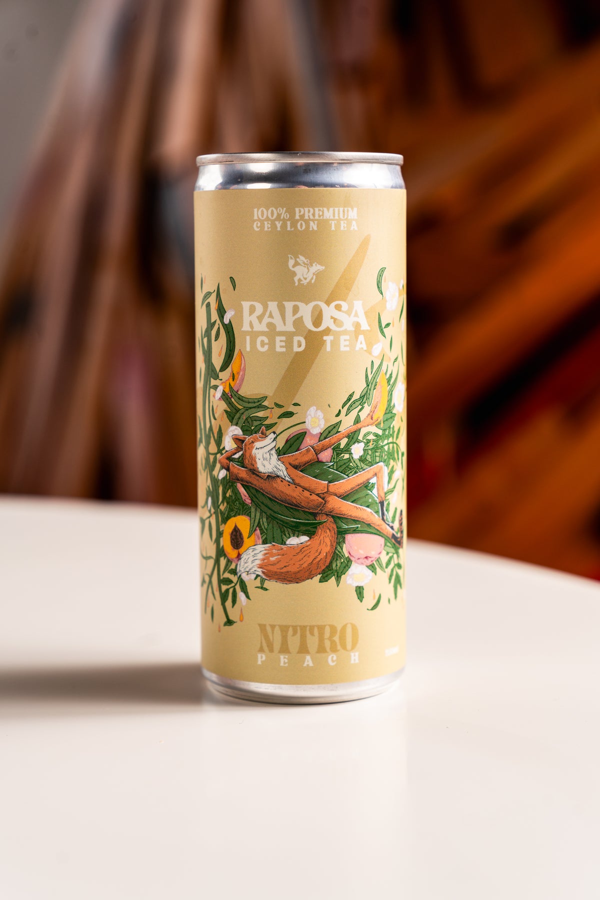 raposa peach iced tea sitting on table
